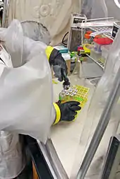 Image of researcher with chemistry equipment in laboratory