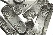 The bars found in Taxila generally use the same motifs but are elongated.