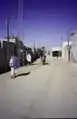 Douz street view with motocyclist, 1997
