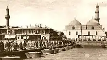 The mosque's minaret as seen on the left next to al-Asifyah Mosque, 1930