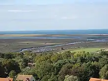 view of a river winding through open wetland