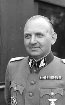 A man wearing a military uniform and various military decorations.