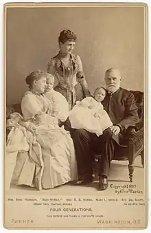 Mary Harrison McKee standing behind her relatives