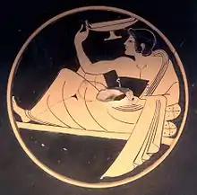 Interior of a red-figure kylix depicting kottabos players. Signed by Pamphaios,  c. 510 BC. Louvre (CA 1585).