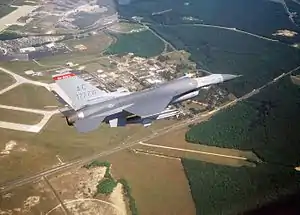 An F-16C Fighting Falcon of the 177th Fighter Wing over its base at Atlantic City Air National Guard Base.