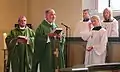 Female servers with bishop and pastor