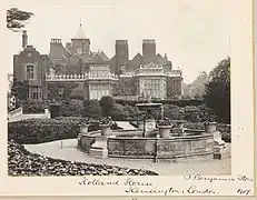 A garden with a fountain on the house's west side