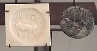 Indus round seal with impression. Elongated buffalo with Harappan script imported to Susa in 2600-1700 BCE. Found in the tell of the Susa acropolis. Louvre Museum, reference Sb 5614