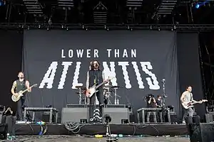 A group of men playing instruments onstage