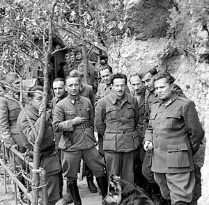 Photograph of a group of uniformed men posing for a photo