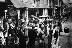 Image 15Men of various ethnicities - Chinese, Malay, and Indian gather at a street corner in Singapore, circa 1900. (from Singaporeans)