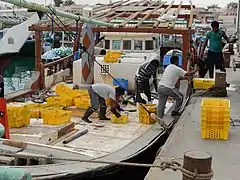 Workers unloading freshly caught fish at the harbor