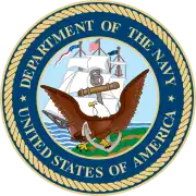 Round seal with a bird in front. Words around the edge say Department of the Navy, United States of America