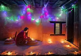 Woman lighting a diyo