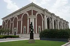 Exterior cornice of the Meadows Museum, with a black sculpture in front.