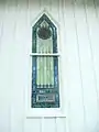 A stained glass window of the church