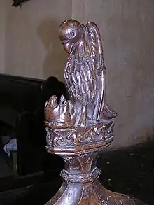 Carving of a bird wounding its breast to feed its young