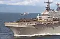 USS Saipan (LHA-2), with USS Mount Whitney (LCC-20) in the background