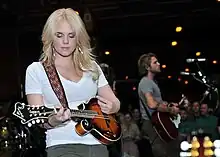 Musician Cheyenne Kimball playing a mandolin.