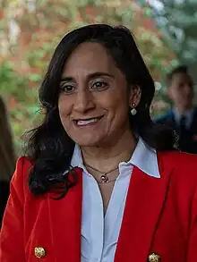 Close-up photograph of a woman speaking into a microphone